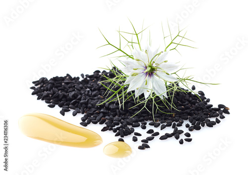 Black cumin oil with seeds and flower