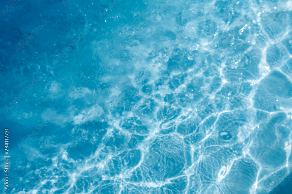 Background of rippled pattern of clean water in a blue swimming pool. Background of rippled pattern of clean water in a blue swimming pool.