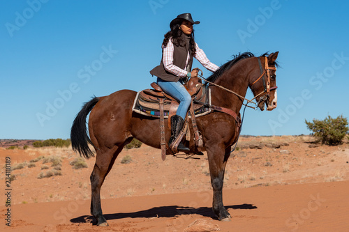 young native american woman riding horse