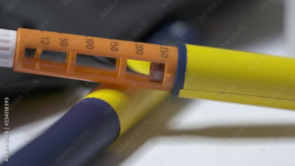 Insulin therapy. Patient with diabetes using diabetic pen to inject