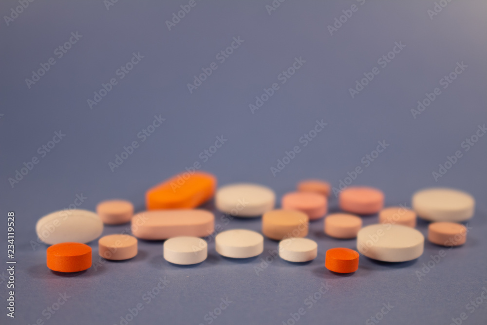 Pills of colors in a neutral background. Medications in the form of tablets. Pills of colors in a neutral background. Medications in the form of tablets.