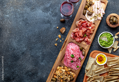 Antipasto Platter. Ham serrano, salami olive jamon dip sauces and red wine