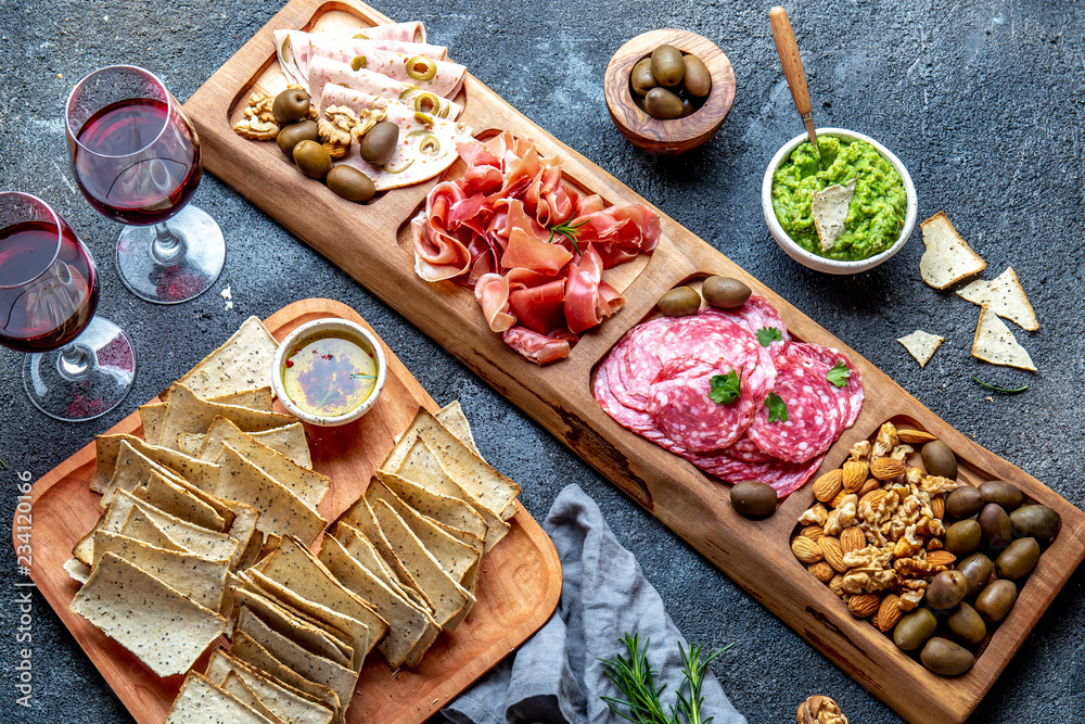 Fototapeta premium Antipasto Platter. Ham serrano, salami olive jamon dip sauces and red wine