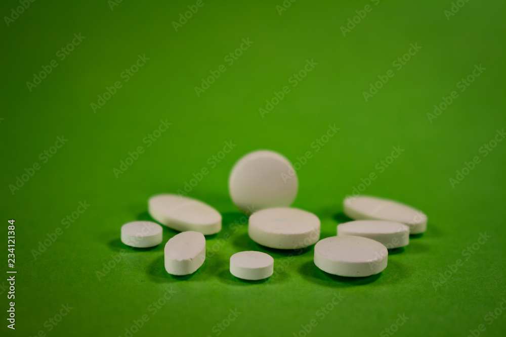 Pills of colors in a neutral background. Medications in the form of tablets.