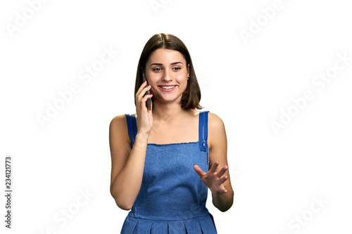 Wallpaper Mural Joyful woman talking on mobile phone. Portrait of happy emotional girl speaking on cell phone over white background. People, technology, emotions. Torontodigital.ca