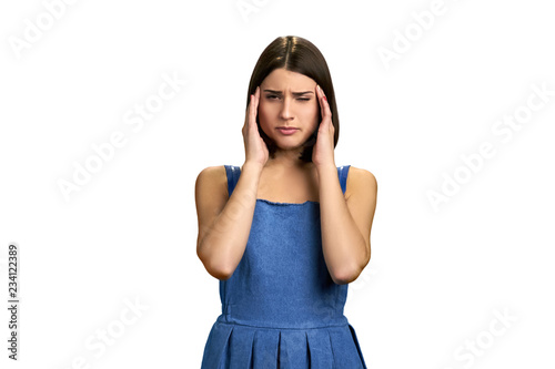 Sick girl with migraine on white background. Stressed exhausted young woman suffering from strong tension headache. Girl feeling pressure and pain.
