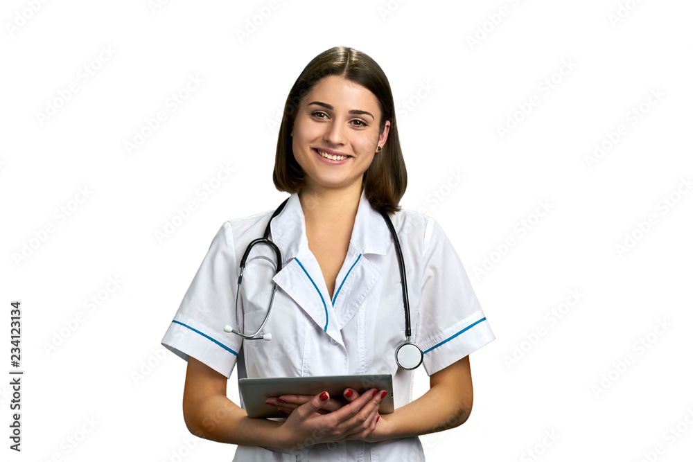 Doctor in uniform holding pc tablet. Happy smiling young woman doctor with portable tablet isolated on white background. Doctor in uniform holding pc tablet. Happy smiling young woman doctor with portable tablet isolated on white background.
