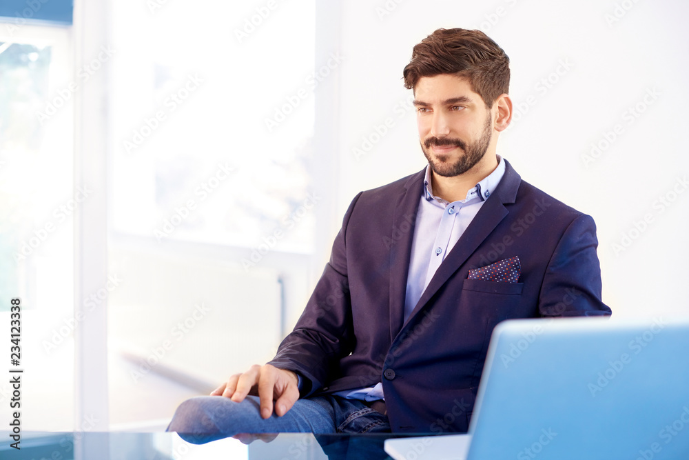 Executive young investment advisor portrait while sitting in the office Executive young investment advisor portrait while sitting in the office