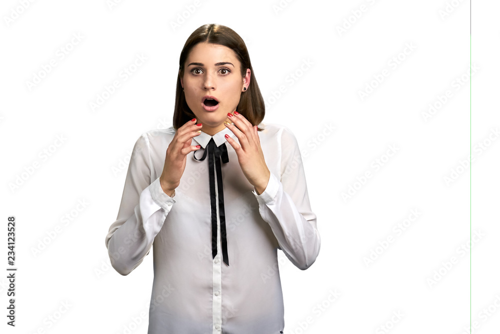 Scared shocked woman on white background. Pretty girl in white blouse with open mouth looking surprised. Face of frightened female.