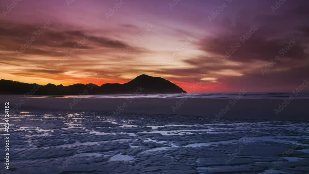 Red sky during sunset on a beautiful remote empty beach in New Zealand. Wharariki beach. Timelapse video. Red sky during sunset on a beautiful remote empty beach in New Zealand. Wharariki beach. Timelapse video.