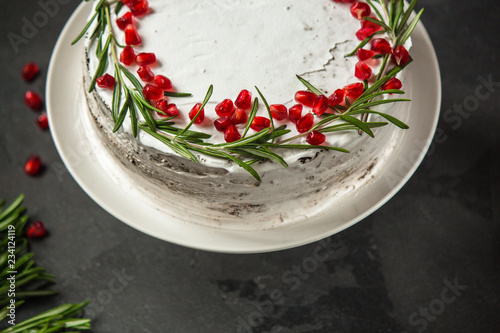 cake with pomegranate and rosemary (chocolate cake). top view.