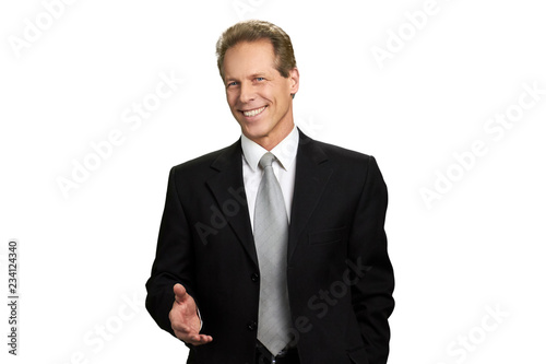 Portrait of friendly businessman with arm out. Handsome businessman with welcome hand gesture isolated on white background.