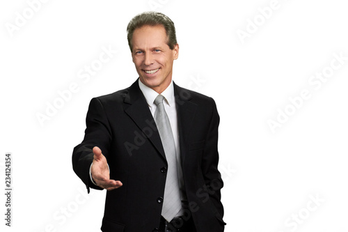 Businessman outstretched hand for greeting. Portrait of businessman extending hand for handshake, isolated on white background.
