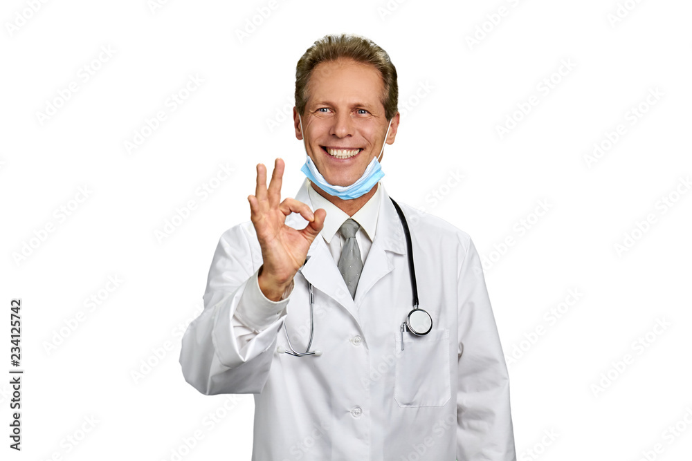 Medical specialist showing excellent gesture. Portrait of smiling surgeon giving okay sign isolated on white background. Treatment and ambulance service concept. Medical specialist showing excellent gesture. Portrait of smiling surgeon giving okay sign isolated on white background. Treatment and ambulance service concept.
