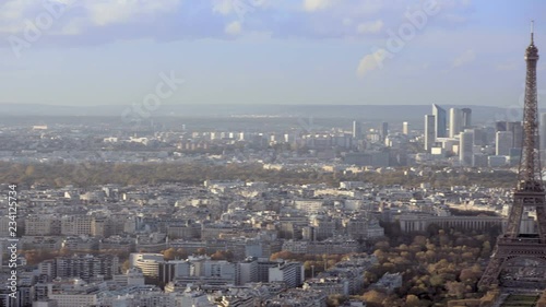 Aerial establishing shot of the Eiffel Tower. Panning left to right. Daytime