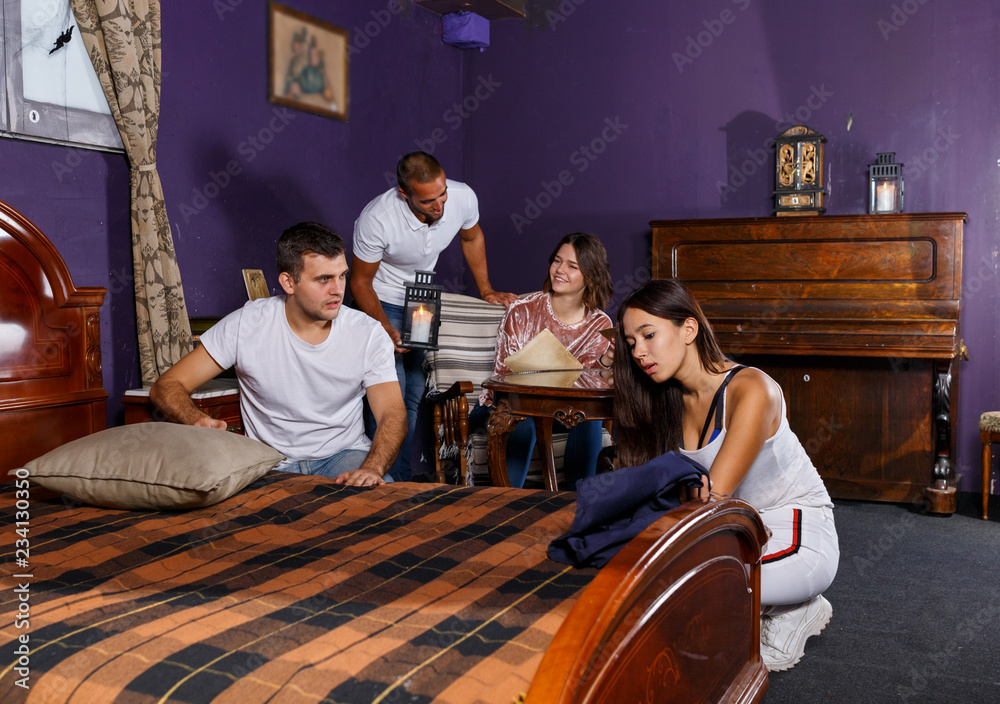 Fototapeta premium Young adults in escape room with antique furnitures