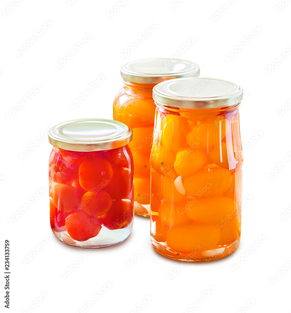 Glass jars with homemade pickled tomatoes, sealed with metal lid Glass jars with homemade pickled tomatoes, sealed with metal lid
