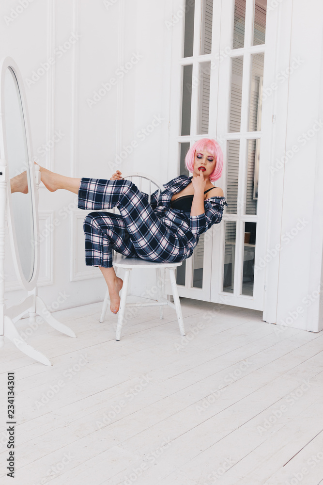 Young woman with pink hair in pajamas Young woman with pink hair in pajamas