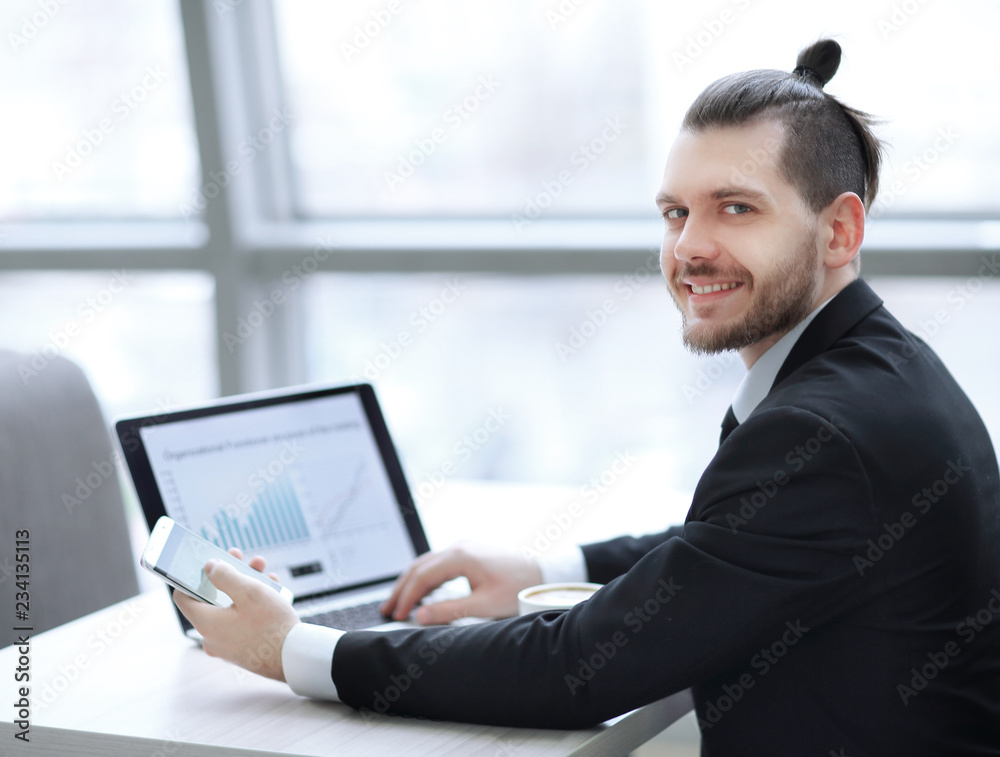 successful businessman is drinking coffee,sitting at his Desk successful businessman is drinking coffee,sitting at his Desk
