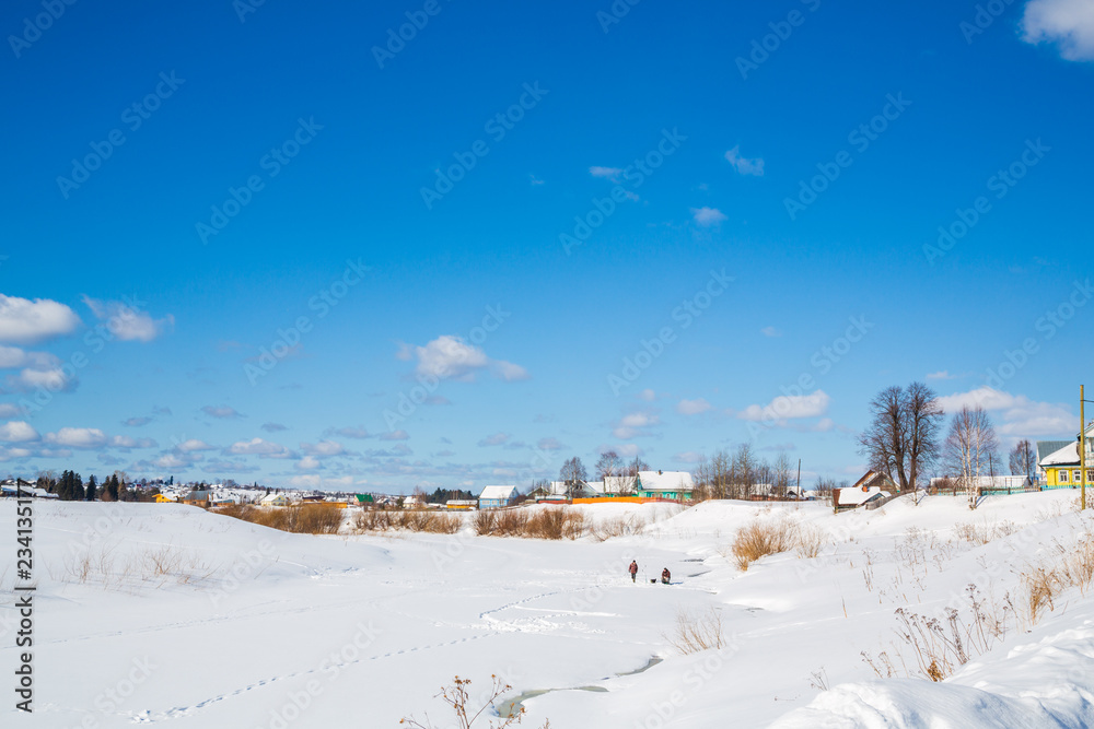 Winter landscape. Countryside. Frozen river. Sunny day. Blue sky. White clouds. Winter landscape. Countryside. Frozen river. Sunny day. Blue sky. White clouds.