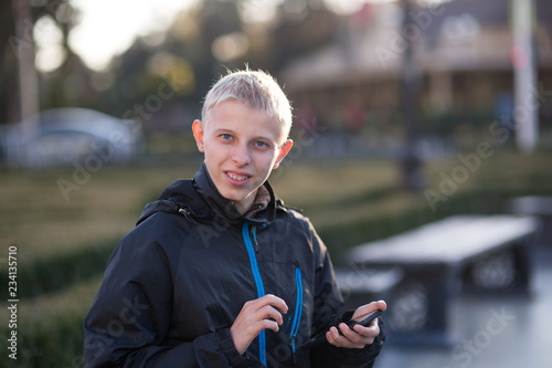 Teenager with a phone in the city