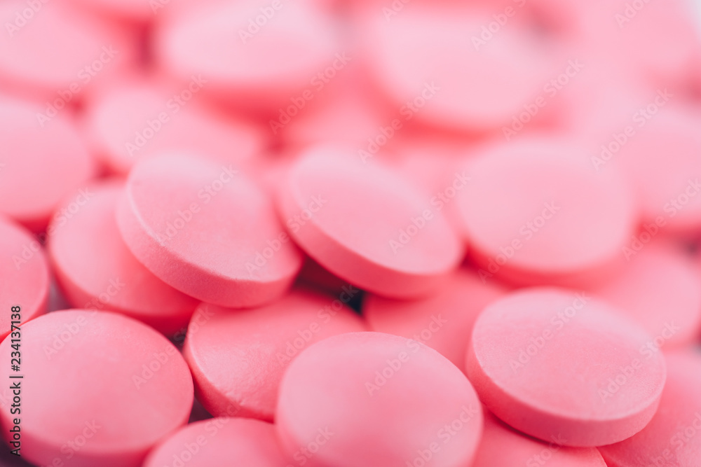 Pink pills close up. Success in the drug business. The concept of drug production. Toned.