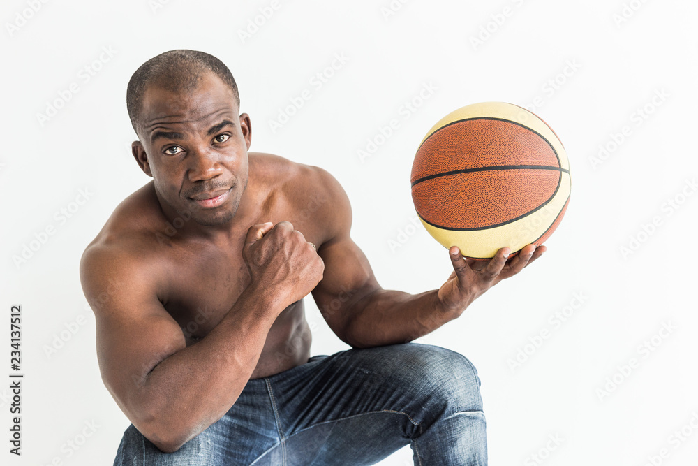 Muscular afro american athlete with basketball ball on white background Muscular afro american athlete with basketball ball on white background