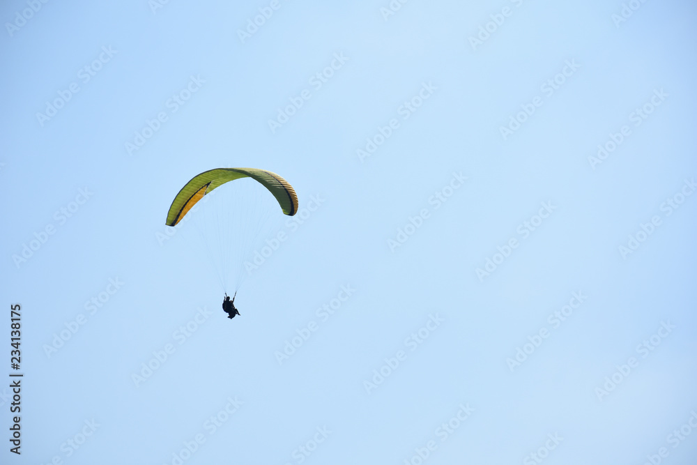 Paraglider on a clear day for background usage. Spaces for type. Paraglider on a clear day for background usage. Spaces for type.
