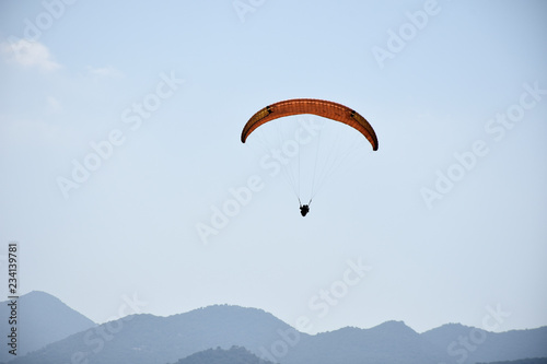 Paraglider on a clear day for background usage. Spaces for type.