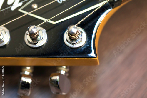 guitar  with wooden brown neck and strings, close up blurry background, texture, abstract