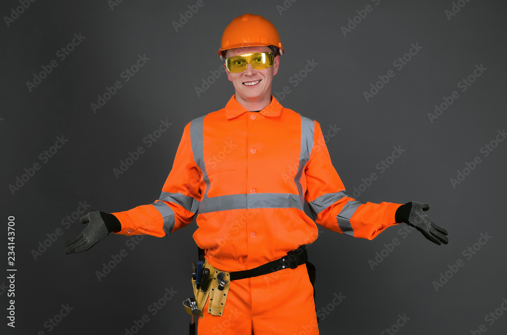 Guilty builder worker justifies about lateness of construction and spreads his hands isolated on blue background. Construction mistake. Guilty builder worker justifies about lateness of construction and spreads his hands isolated on blue background. Construction mistake.