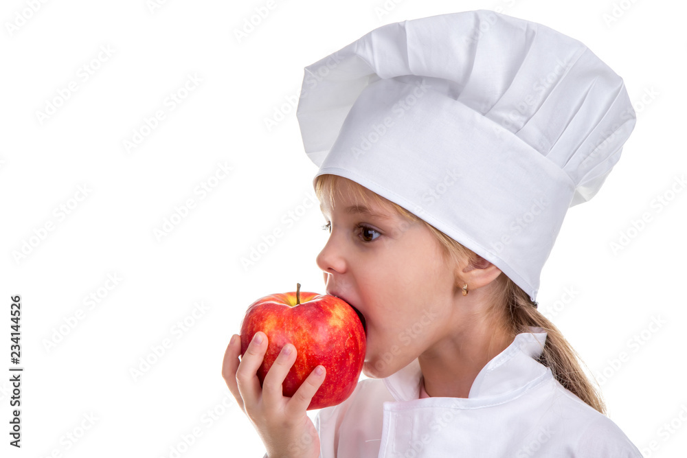 Little girl in a cook cap biting the red apple. Concept of healthy food and healthy lifestyle. Profile image Little girl in a cook cap biting the red apple. Concept of healthy food and healthy lifestyle. Profile image