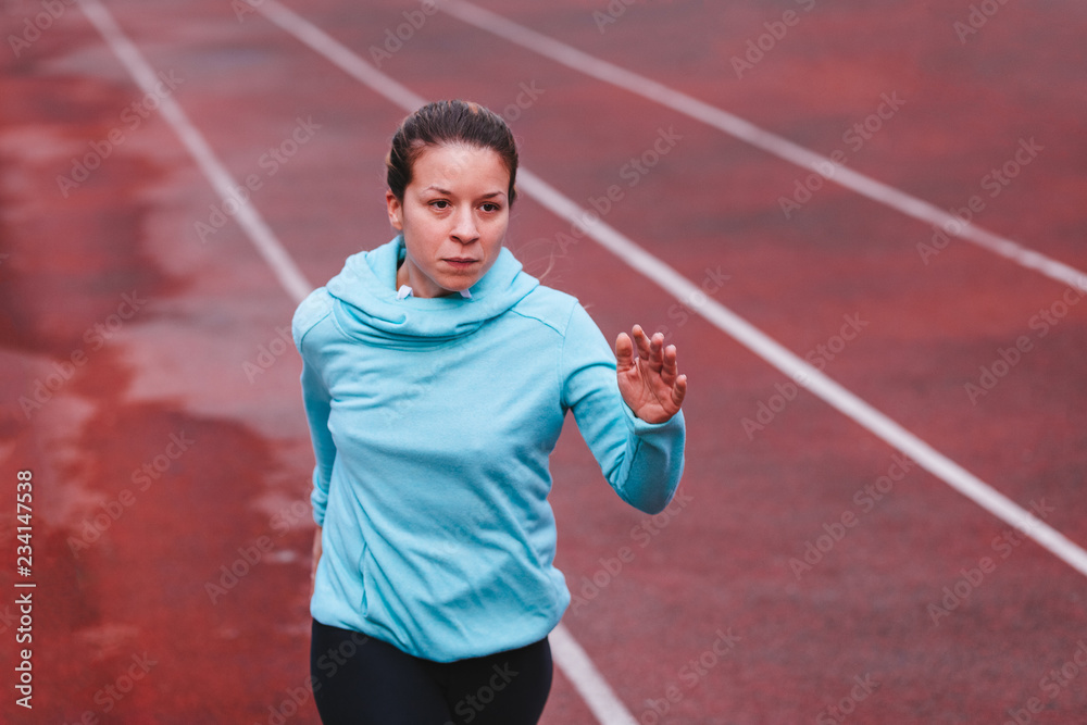 Woman running. Female runner jogging, training for marathon. Fit girl fitness athlete model exercising outdoor.