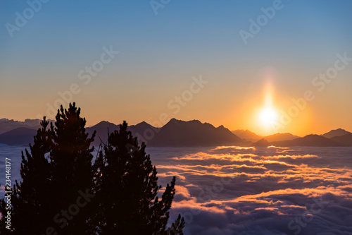 Sunset over sea of fog photo