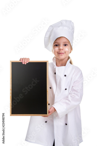 Cute smiling girl chef white uniform isolated on white background. Girl with a floured face holding a menu black empty board. Portrait image