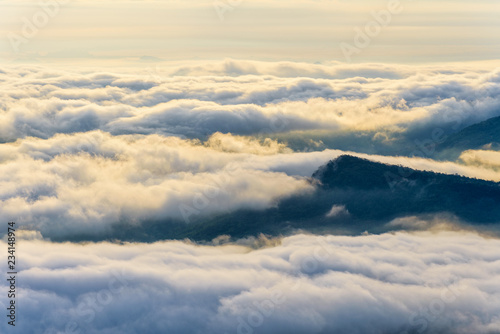Beautiful nature landscape clouds and fogs like the sea is covered peaks in winter morning during sunrise at viewpoint of Phu Ruea National Park, Loei province, Thailand