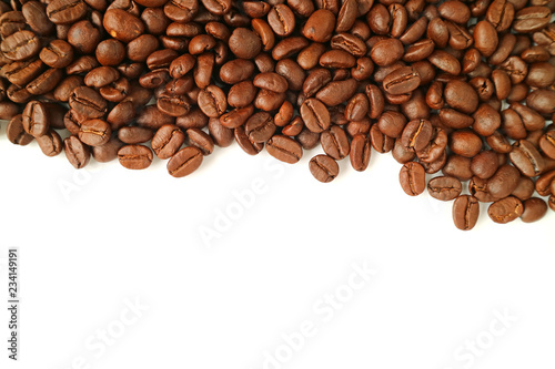 Top view of heap of roasted coffee beans isolated on white background with free space for text or design 