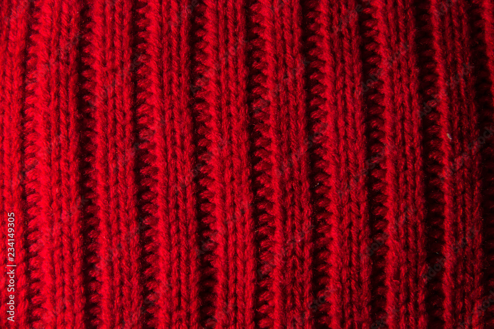 texture of knitted stripes of red yarn