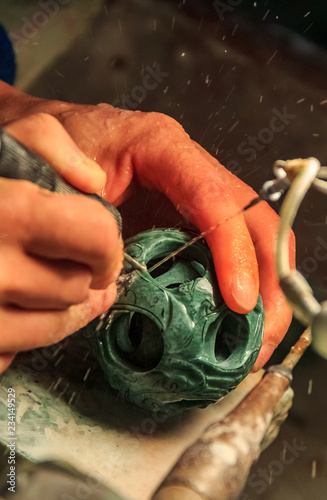 Craftsman working on a jade ball in a jade factory near Beijing China