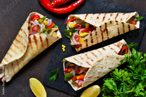 Taco - traditional dish of Mexican cuisine. Mexican tacos with beef, vegetables and sauce. Top view.