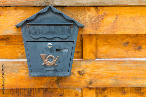 A beautiful mailbox hangs waiting for newspapers, parcels and letters.