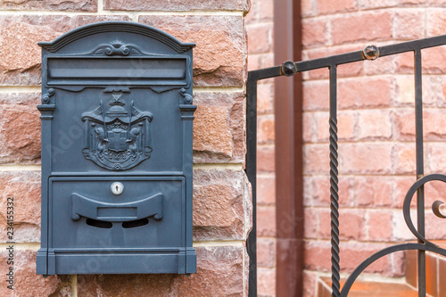 A beautiful mailbox hangs waiting for newspapers, parcels and letters.