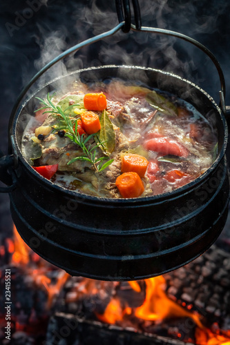 Delicious and fresh hunter's stew on campfire