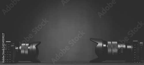 Two mirror less digital camera on a black background 