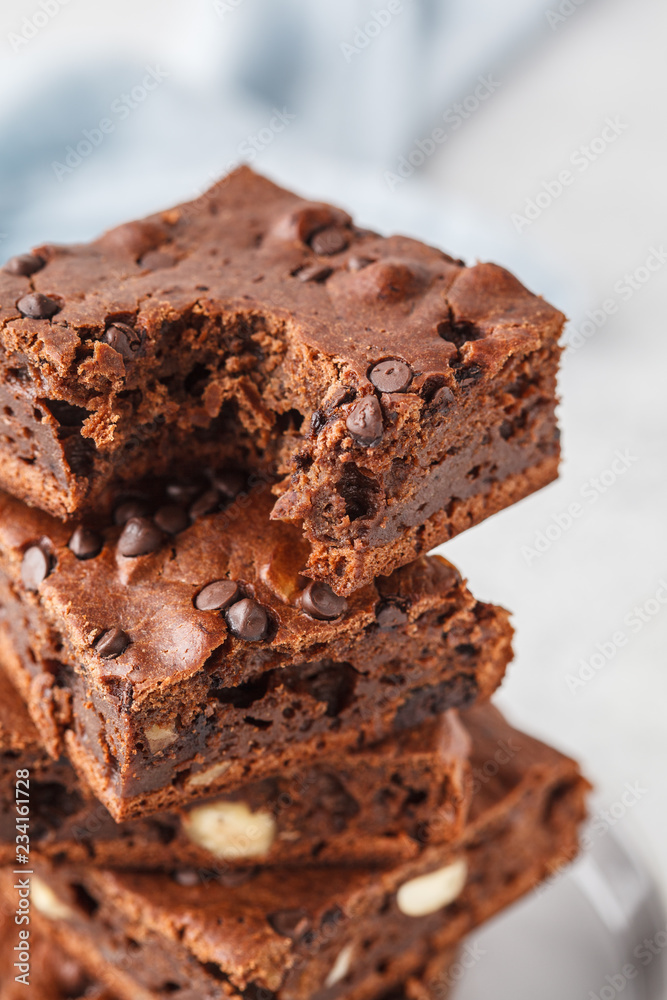 Stack pieces of chocolate vegan cake with chocolate drops and nuts. Stack pieces of chocolate vegan cake with chocolate drops and nuts.