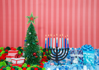Christmas tree with presents next to Hanukkah menorah burning candles, dreidel, and gifts with yarn balls in holiday colors. Many multi faith families celebrate both Xmas and Hanukkah. Chrismukkah.