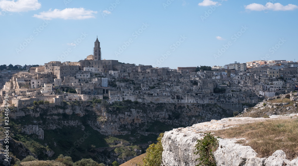 Houses built into the rock in the cave city of Matera, Basilicata Italy. Matera has been designated European Capital of Culture for 2019. Photographed from inside a cave in the ravine opposite.