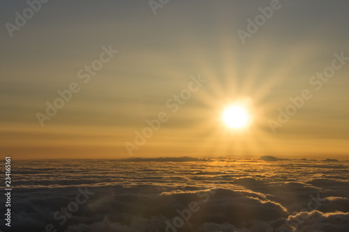 View from volcano Pico del Teide in Tenerife  right at sunrise time with a glowing sea of clouds reaching to the horizon