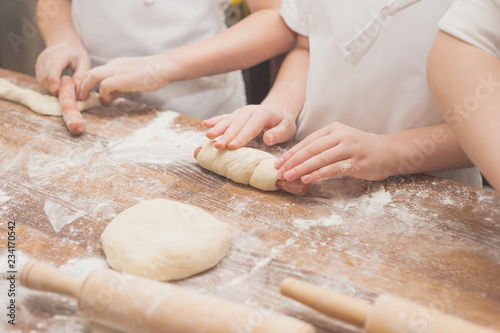 Young children make sausage dough. Hands closeup