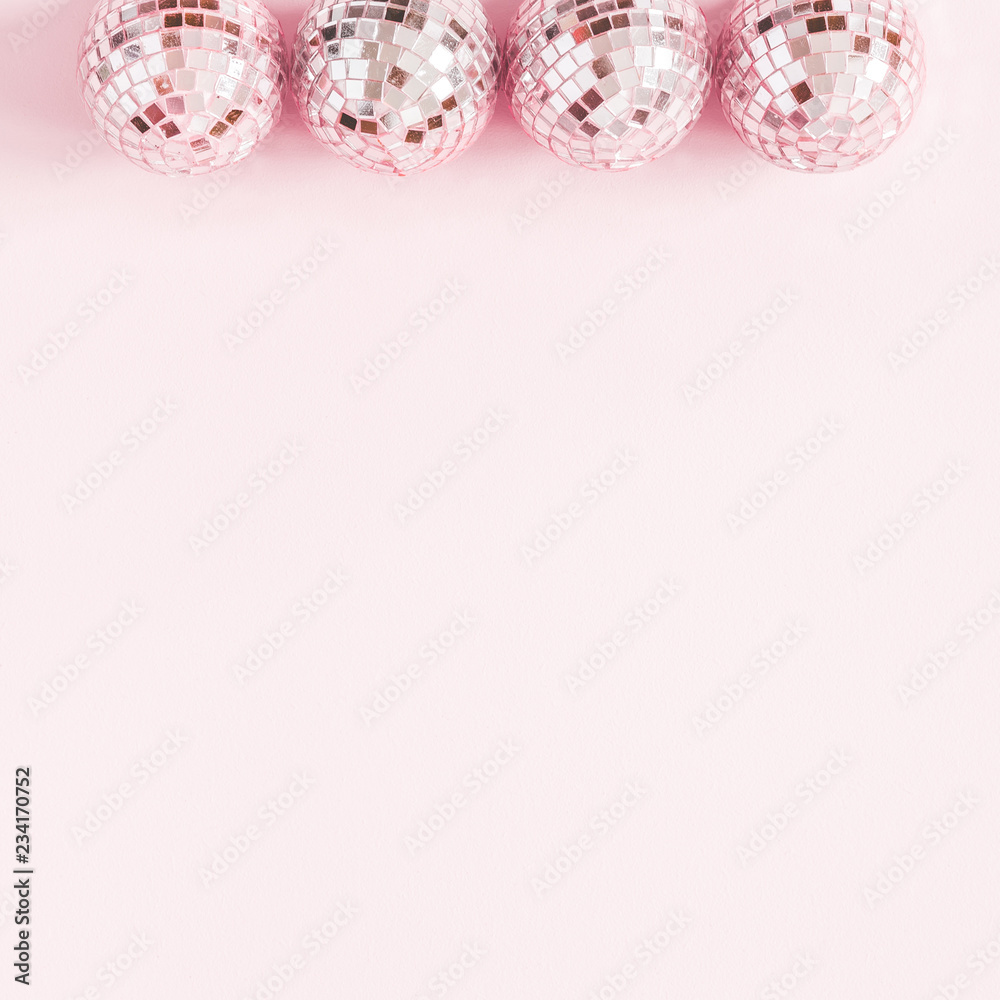 Christmas composition. Frame made of pink disco balls on pastel pink background. Christmas, winter, new year concept. Flat lay, top view, copy space, square